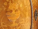 a wooden cabinet with a floral design on it