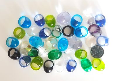a lot of different colored plastic beads on a white surface