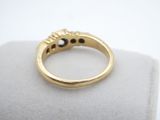 a close up of a gold ring on a white surface
