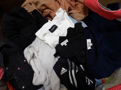 a pile of clothes that is sitting in a suitcase