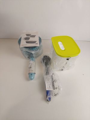 a plastic container with a toothbrush, toothpaste, and other items on a table