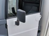 a white truck with a door open in a parking lot