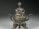 an old bronze incense box with a dragon on top