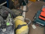 a vacuum that is sitting on the floor in the garage