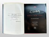 an open book with a handwritten signature on the cover