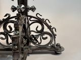 a close up of a metal candle holder on a white surface