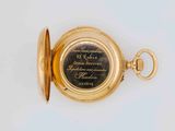 gold plated pocket watch with engraved quote on the dial
