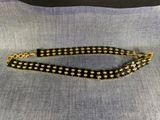 a black and gold beaded bracelet with a gold chain