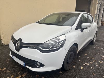 a white car is parked in front of a building