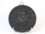 a black plate with a circular design on it