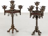pair of antique brass candelabs with red and gold accents