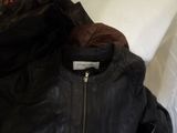 the jacket is black and has a zipper on the back