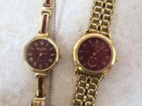 pair of ladies ' s wrist watches sitting on a table next to each other