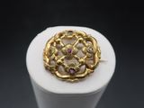 a close up of a gold ring on a white surface