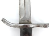 a close up of a knife on a white surface