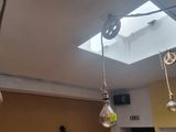 three light bulbs hanging from the ceiling in a room