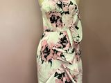 a dress on a mannequin stand with a pink and black floral print