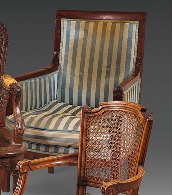 pair of antique carved wood chairs with striped upholstered cushions