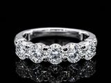 a close up of a diamond ring on a black surface