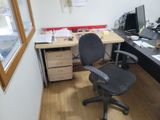 a desk with a chair and a computer on it