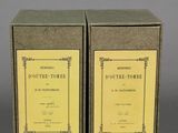 pair of two boxes with a yellow label on them on a gray surface