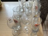 a lot of empty glasses on a table with a basket on the side