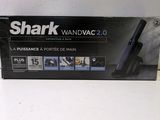 the box of the shark wandvacg 2 0 is open on the table