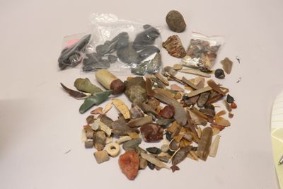 a pile of rocks and other items on a table