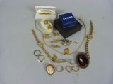 a lot of gold and silver jewelry on a white table