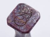 a purple stone with a bird on top of it