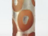 a glass vase with an orange and white design on it