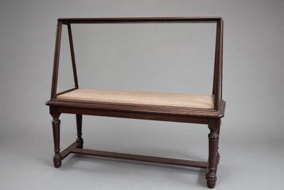 an old wooden bench with a cushion on top of it