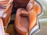 a brown leather seat in the back of a car
