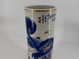 a blue and white vase with a dragon on it