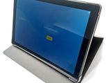 the tablet is sitting on top of a stand with a blue screen