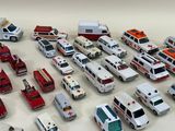 a lot of toy ambulances and cars on the table