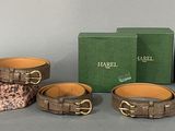 three pieces of leather bracelets and a green box on a table