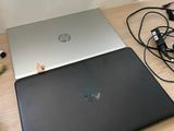 two laptops that are sitting on a wooden table