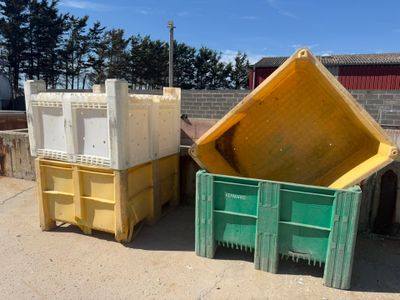 two yellow and green bins sitting next to each other
