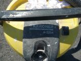 a yellow trash can with a black handle and a black hose
