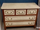a white and brown chest of drawers next to a blue wall