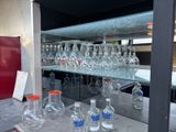 many empty glass bottles on the counter in the kitchen
