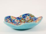 a close up of a blue bowl with flowers on it