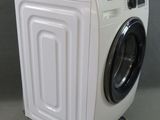 an image of a white washing machine on a gray surface