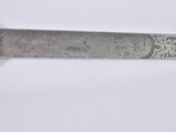 a close up of a knife on a white surface with a white background