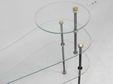 three glass and brass coffee tables with glass tops on a white background