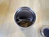 a silver cup with a spoon in it sitting on a table
