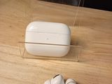 two airpods that are sitting on a wooden table