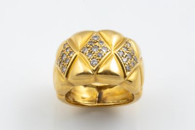a close up of a gold ring with diamonds on a white background