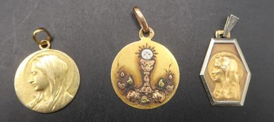 three gold and silver lockes with a woman ' s face on them